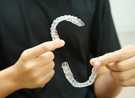 Dental professional holding two clear aligners
