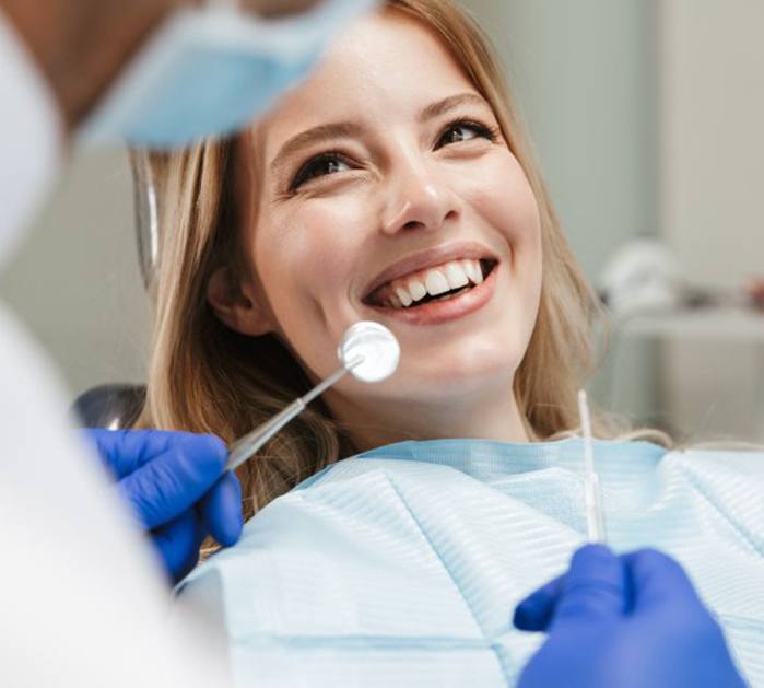 Lady smiles at dentist