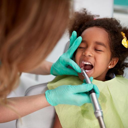 Patient sits in dentist’s chair