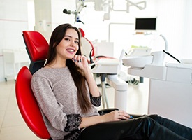 Woman smiling from the patient’s chair