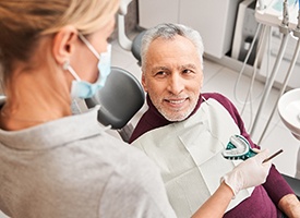 Dentist making impressions of man’s teeth for dentures