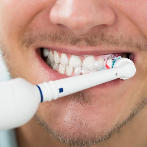 Dental patient brushing teeth to preventive dental emergencies