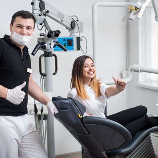 Dentist and patient giving thumbs up