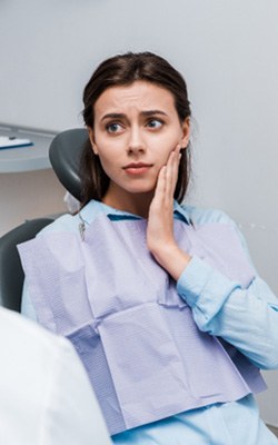 Woman visiting emergency dentist near Heights Village