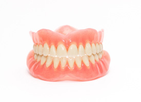 Complete set of shining dentures with white background