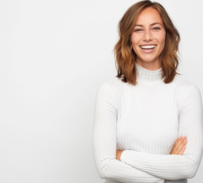 Woman in white sweater showing off her smile makeover in Chevy Chase
