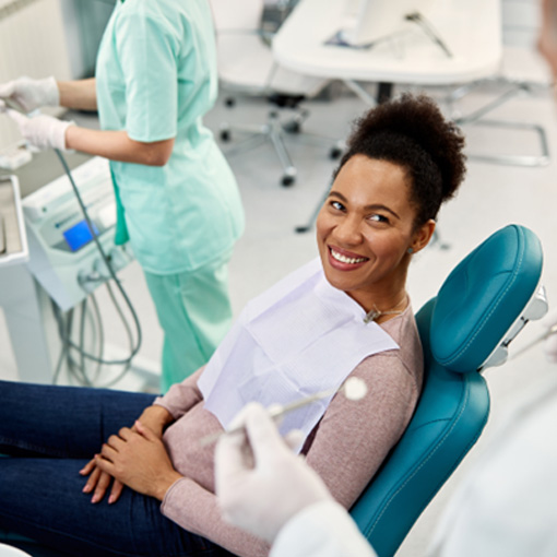Dentist talking to female patient about smile makeover options