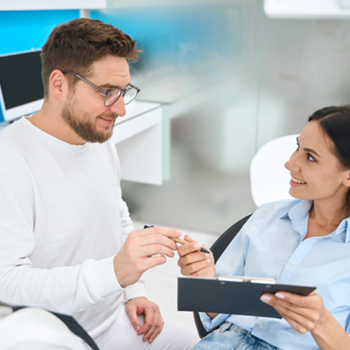 Dental team member discussing cost with female patient