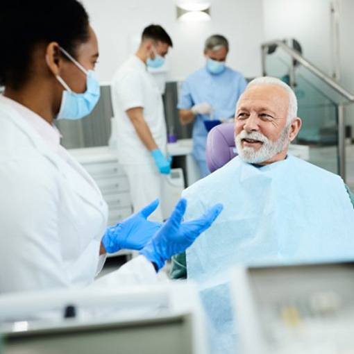 a patient speaking with his dentist after receiving care
