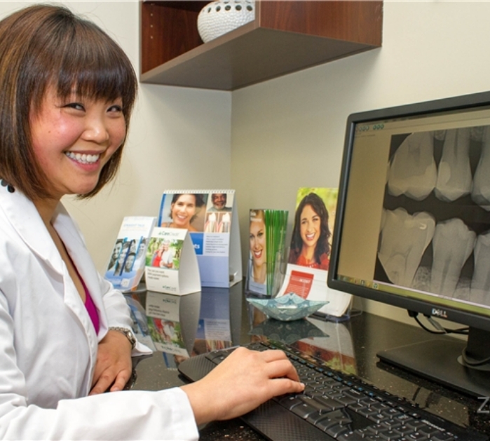 Dentist reviewing treatment plan for dental services