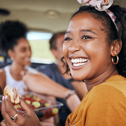 a person eating lunch with her friends in a car