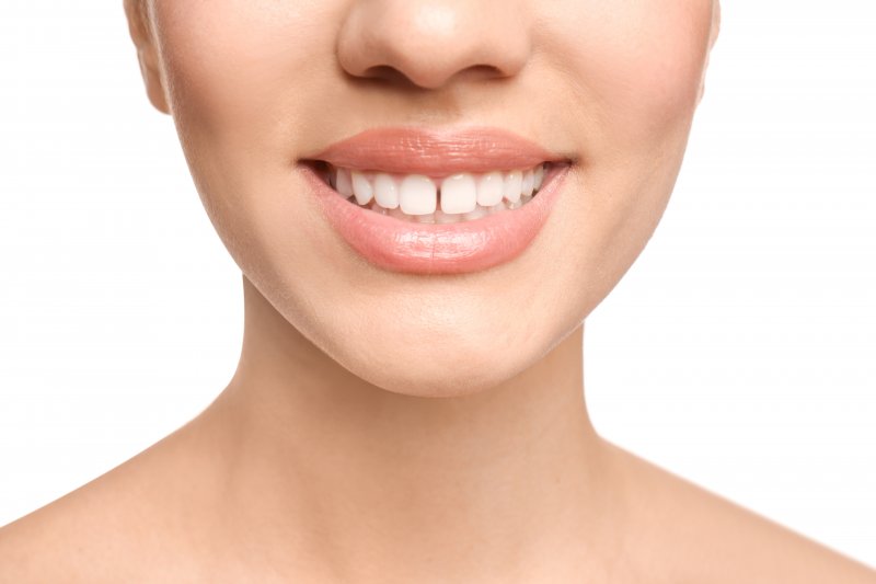 Woman smiles with gap between two front teeth