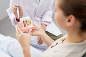 Woman listening to her dentist talk about dental implants